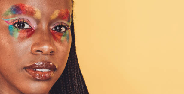 portrait african woman smiling tribal face paint, yellow face paint; headshot close-up
