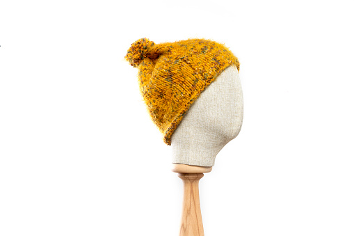 Mustard knit hat/beanie with mannequin head on white background