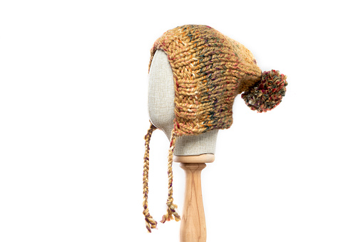 Yellow knit hat/beanie with mannequin head on white background