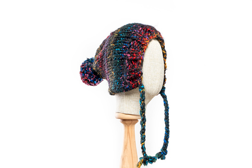 colourful knit hat/beanie with mannequin head on white background