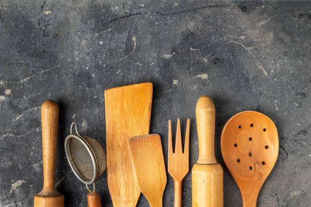 istock set of wooden kitchen utensils on a blue background, copy space 1395492346