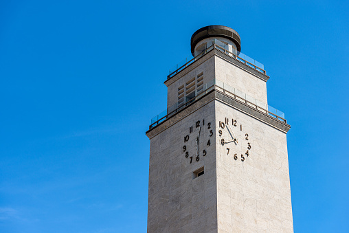 Brescia downtown. Close-up of the Clock Tower of the Fascist Revolution (Torre della Rivoluzione Fascista), 1927-1932, by the Roman architect Marcello Piacentini (1881-1960), Piazza della Vittoria (Victory Square), Lombardy, Italy, Europe.