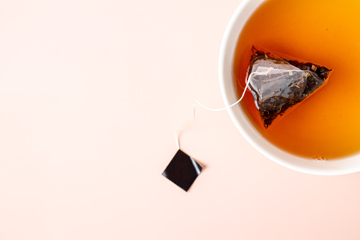 cup of citrus tea and tea bag, close-up