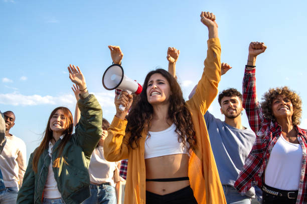 une jeune dirigeante militante prononce un discours et encourage les manifestants lors d’une manifestation pour les droits humains. - protestor photos et images de collection