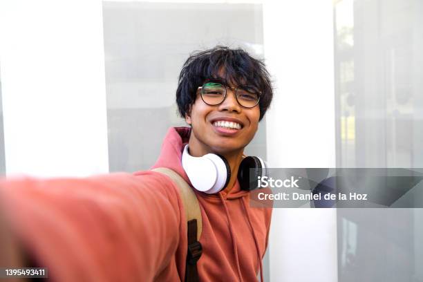 Asian Adolescent Male Taking Selfie With Phone Looking At Camera Teen Boy College Students Take Photo Of Himself Stock Photo - Download Image Now