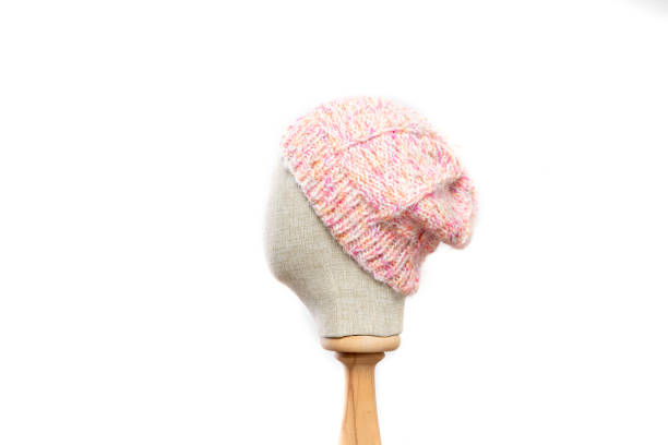 istock Pink knit beanie with mannequin head on white background 1395493430