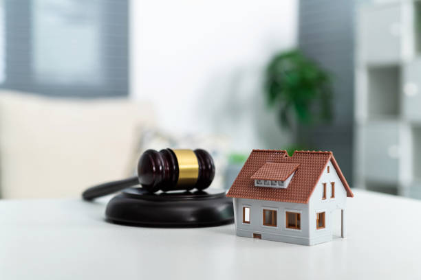 istock Model house and gavel on the table 1395493520