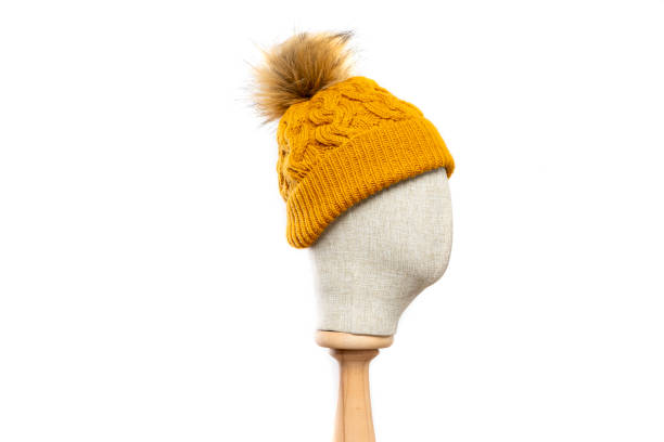 istock mustard knit beanie with mannequin head on white background 1395493596