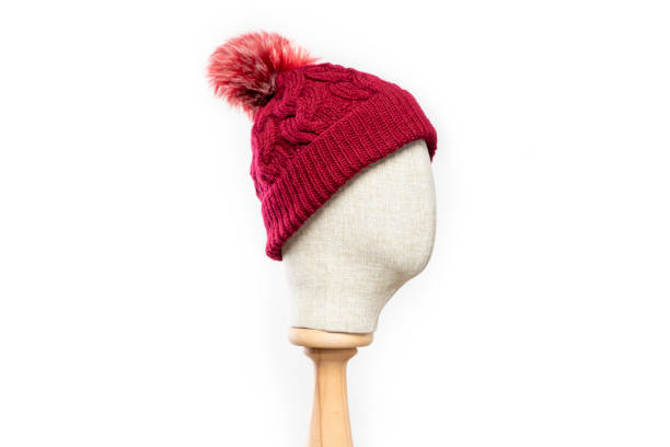 istock Red knit beanie with mannequin head on white background 1395493937