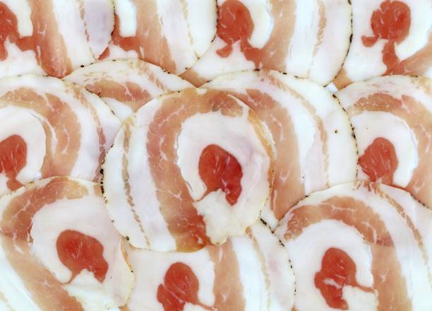rolled pancetta slices. it is an italian salty pork belly, similar to the bacon. - pancetta imagens e fotografias de stock
