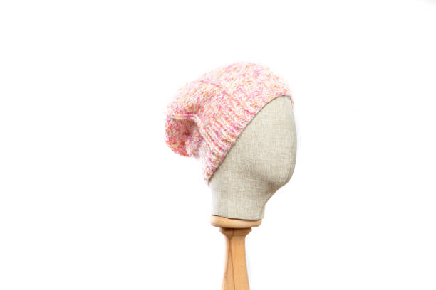 istock Pink knit beanie with mannequin head on white background 1395496483