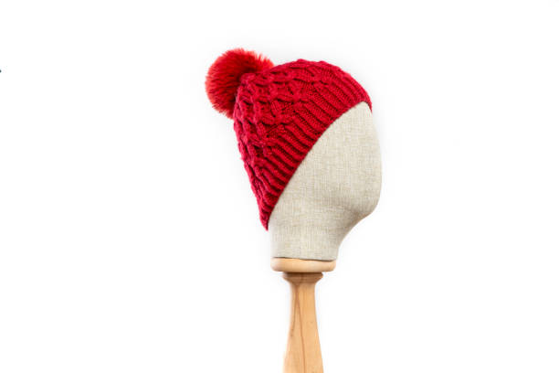 istock Red knit beanie with mannequin head on white background 1395497572