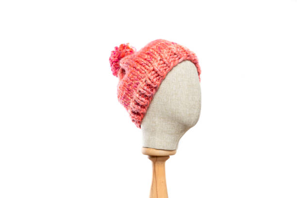 istock Pink knit beanie with mannequin head on white background 1395497903