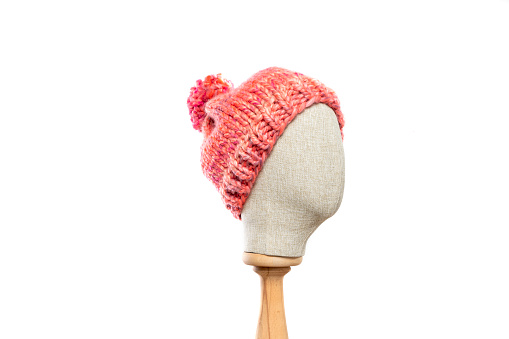 Pink knit hat/beanie with mannequin head on white background