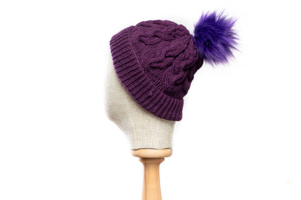 istock Purple  knit beanie with mannequin head on white background 1395497968