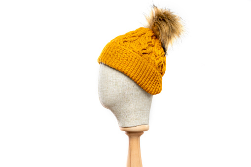 mustard knit hat/beanie with mannequin head on white background