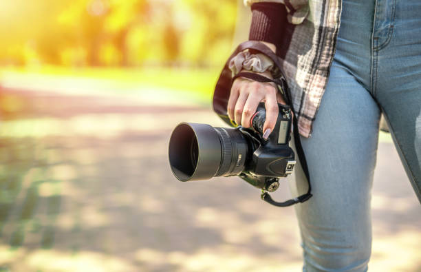 istock Freelance female photographer holding a camera. Creative occupation concept 1395499729