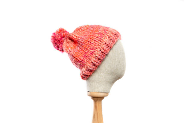 istock Pink knit beanie with mannequin head on white background 1395502704