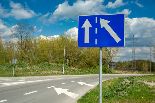 istock Blue rectangle road sign and white arrows 1395502839