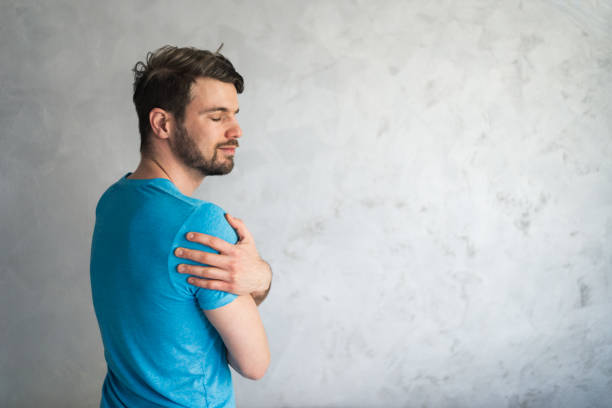 istock Smiling loving young man hugging oneself 1395504645