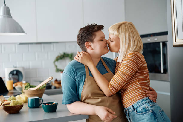 istock Affectionate lesbian couple kissing in the kitchen. 1395508146