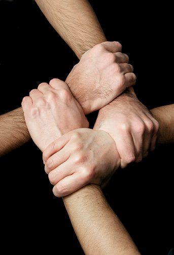 4 male hands linked at the wrist,sidelighting,detail in hands