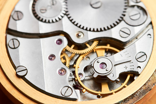 vintage watch mechanism over black background
