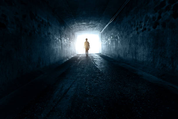 A boy standing at the end of the tunnel A boy standing at the end of the tunnel. one teenage boy only stock pictures, royalty-free photos & images