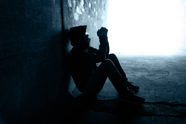 One man sitting in the dark tunnel.