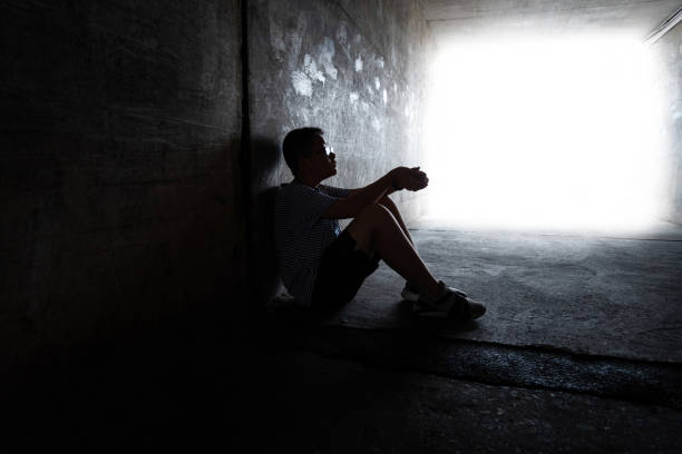 istock A boy sitting in the dark tunnel 1395514959