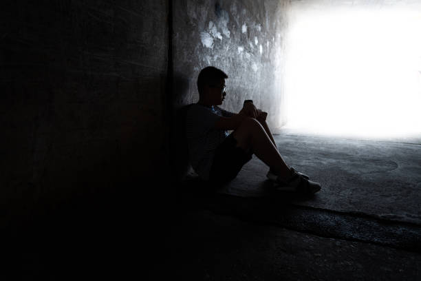 istock A boy sitting in the dark tunnel 1395514962