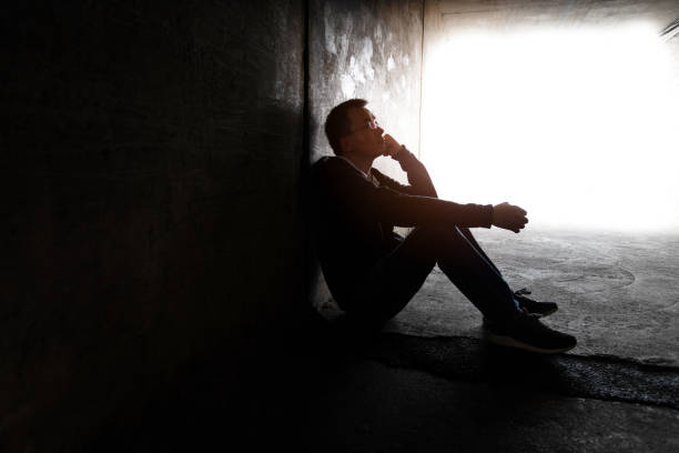 istock One man sitting in the dark tunnel 1395514999