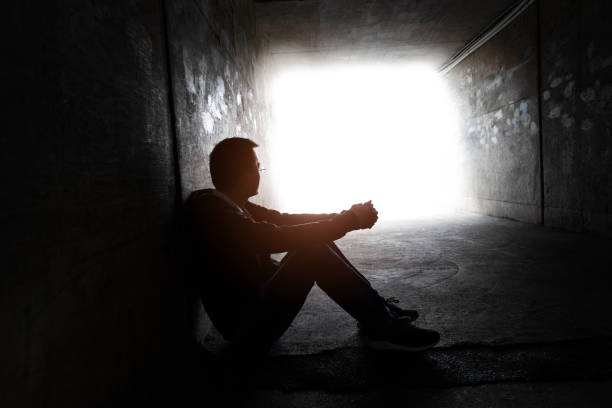 istock One man sitting in the dark tunnel 1395515021