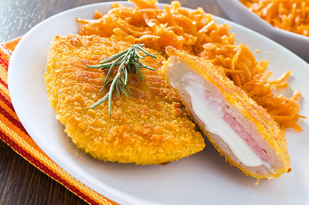 cordon bleu di pollo con carote grattugiate. - chicken baked chicken breast breaded foto e immagini stock