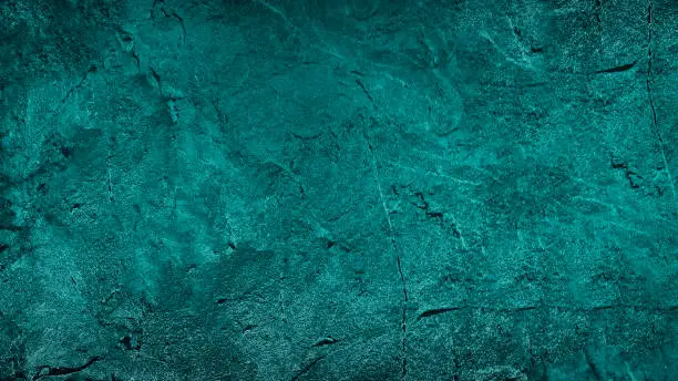Photo of Blue green abstract background. Toned rough rock surface texture. Beautiful teal background with copy space for design.
