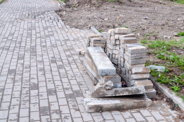 istock pavement repairs. laying bricks for the pavement 1395520449