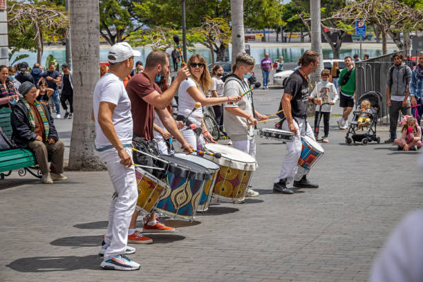 A couple of drummers marching in a Christmas parade,
