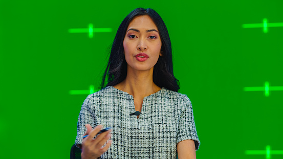 Newsroom TV Studio Live News Program with Green Screen Background: Female Presenter Reporting, Talking. Television Cable Channel Anchorwoman. Network Broadcast Mock-up Playback with Tracking Markers