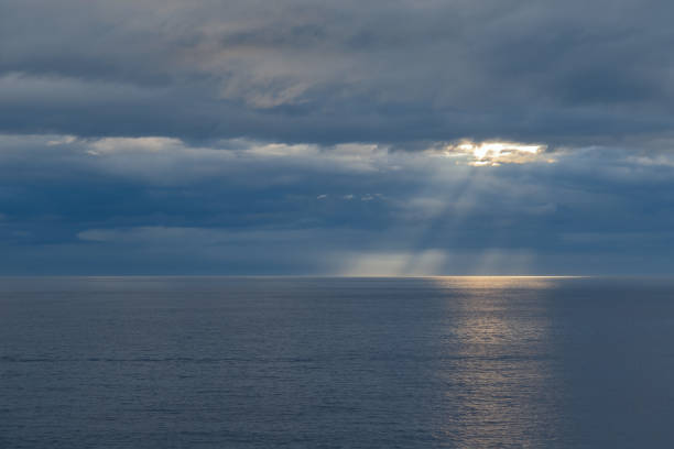 istock The sun's rays through a cloudy sky over the sea 1395525020