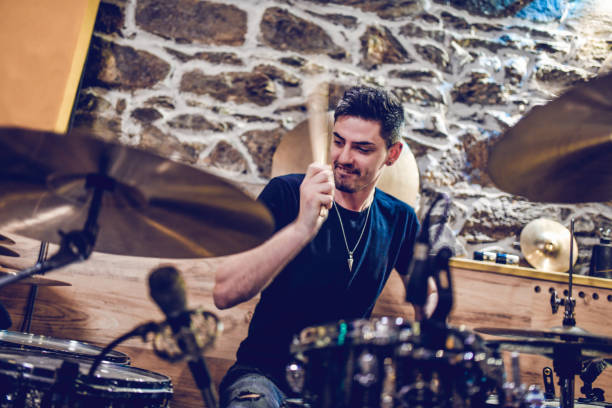 istock Handsome Male Preparing For The Solo Performance With Drums 1395525572