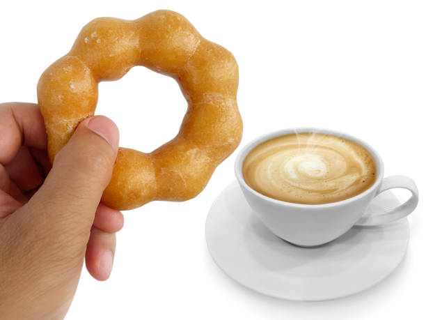 istock donut in man's hand and Hot coffee isolated on white background 1395527221