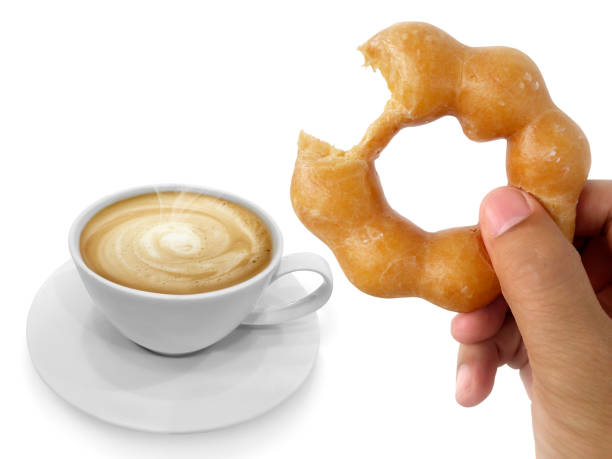 istock donut in man's hand and Hot coffee isolated on white background 1395527222