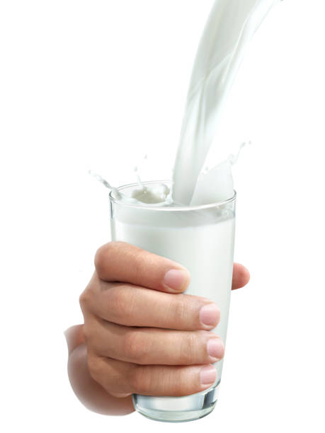 istock hand with glass of milk on a white background 1395528464