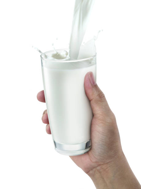 istock hand with glass of milk on a white background 1395528465