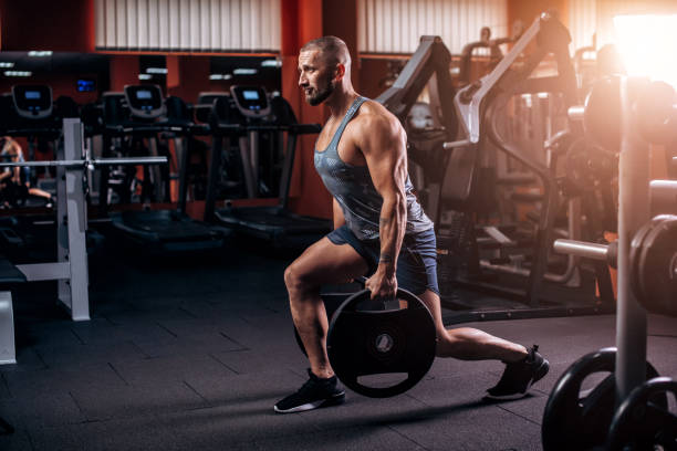 istock Handsome muscular man exercise in the gym. Legs day. 1395530184