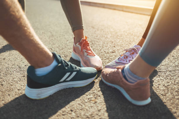 istock People's feet wearing running shoes 1395530341