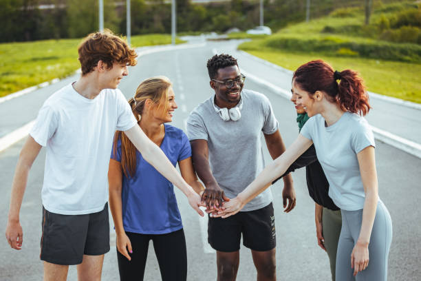 istock Happy multi-ethnic sporty friends stacking hands 1395530806