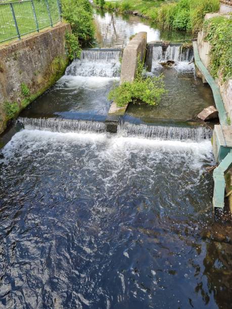 istock Flowing Water At A River Weir 1395530820