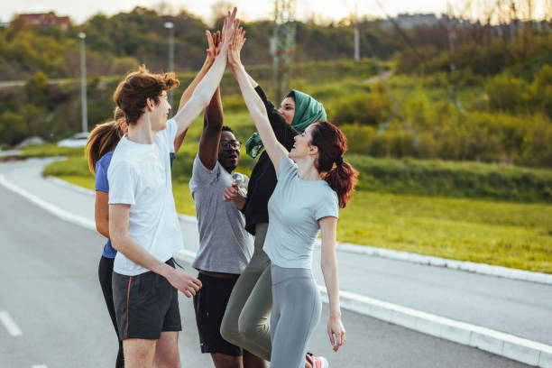 istock Happy fitness multiethnic class giving high five after completing exercise session 1395531535