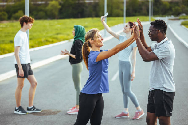 istock Runners high fiving each other after a good training session. 1395531657
